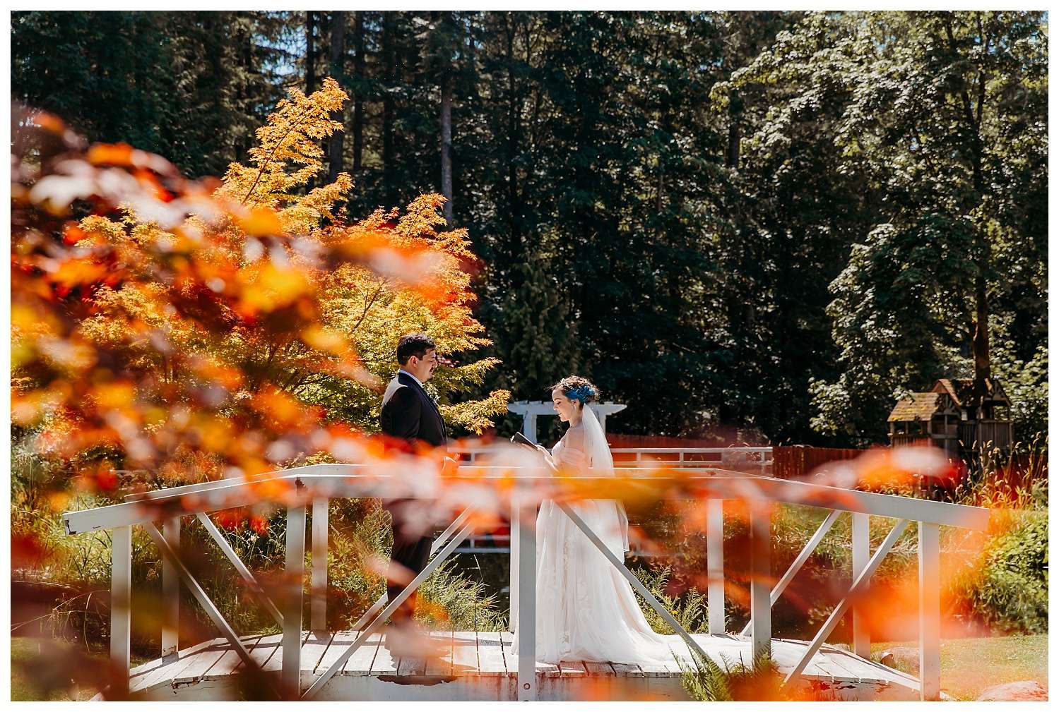 Bride and groom exchanging Vows on a bride on a sunny day with fall leaves